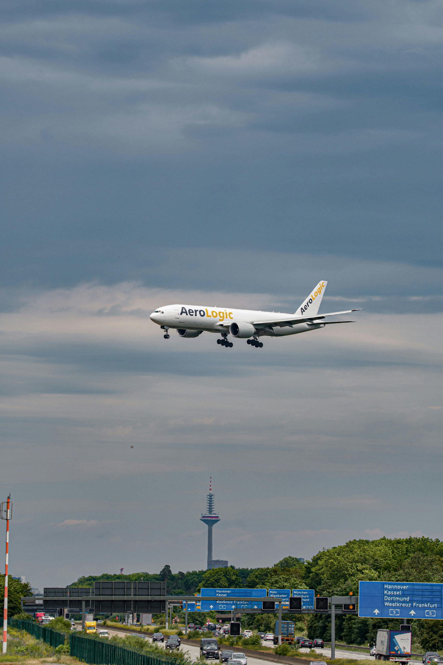 AeroLogic plane preparing to land at Frankfurt Airport with cloudy skies.